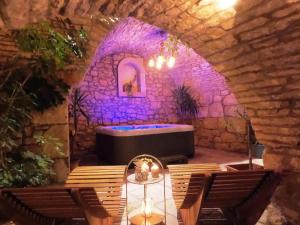 a room with a bath tub in a stone wall at Stone House Hedonia in Blato
