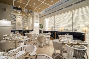 a dining room with white tables and chairs at Hyatt Regency Cartagena in Cartagena de Indias
