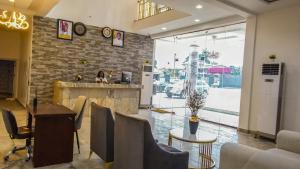 a lobby of a restaurant with a table and chairs at Royal Modak Resort & Hotel in Ibadan
