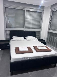 a bedroom with a bed with two towels on it at Luxury Duplex With Private Pool in Eilat +28 photos