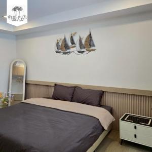 a bedroom with a bed with three sails on the wall at The White Palm Villa & Pool in Khon Kaen +19 photos
