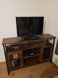 a wooden entertainment center with a television on top at Haus Flora in Hasselfelde