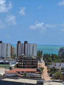 a view of a beach with buildings and the ocean at Condomínio Reserva Almagre - MH in João Pessoa