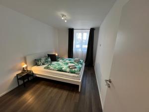 a small bedroom with a bed and a window at Apartmány ASTRA in Cheb