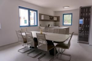 a dining room with a table and chairs at Vila JELSANA in Jelsa