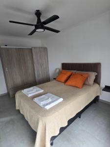 a bedroom with a bed with a ceiling fan at Lago Santa Ana in Santa Ana
