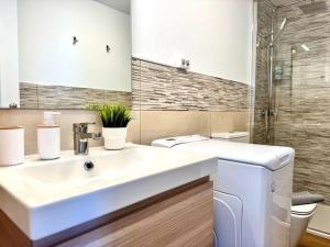 a bathroom with a white sink and a shower at NextGen Casa Ilma in Antigua +30 photos