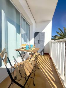 a balcony with a table and chairs in a room at NextGen Casa Ilma in Antigua
