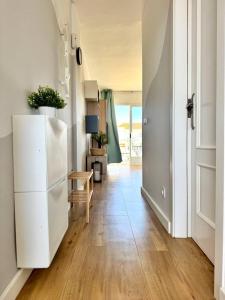 a hallway with a white refrigerator in a room at NextGen Casa Ilma in Antigua