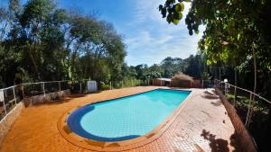 a swimming pool in the middle of a yard at Camping e Hostel Internacional in Foz do Iguaçu