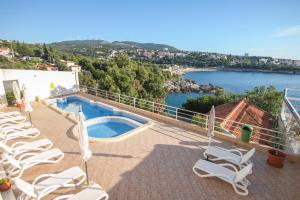 a balcony with chairs and a swimming pool at Aleksandra Apartments Utjeha in Utjeha +44 photos