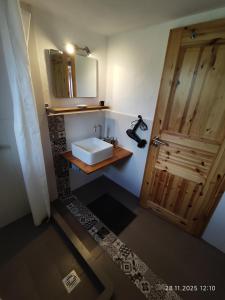 a bathroom with a sink and a wooden door at Villa Seaview in Oitylo