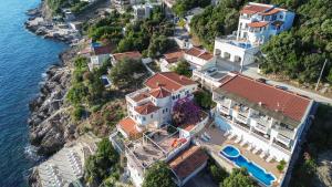 an aerial view of a house on a hill next to the water at Aleksandra Apartments Utjeha in Utjeha
