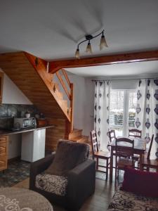 a living room with a couch and a dining room at Agroturystyka pod Baranią Gorą in Kamesznica