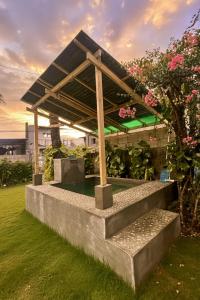 a bench in a garden with a roof at Loft Baler with Kitchen & Ideal for Work from Home Setup in Baler