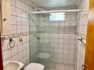 a bathroom with a toilet and a sink at Pousada Convés das Ondas in Penha +76 photos
