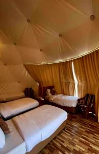 a room with two beds in a tent at Wadi rum camp in Wadi Rum