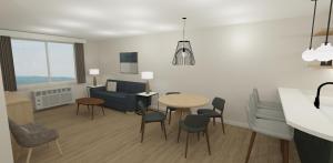 a living room with a table and chairs and a couch at XStay Suites Mansfield in Mansfield
