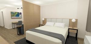 a hotel room with a bed and a desk and a desk at XStay Suites Mansfield in Mansfield