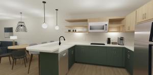 a kitchen with green cabinets and a white counter top at XStay Suites Mansfield in Mansfield