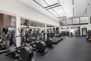 a gym with a lot of treadmills and machines at Stylish Studio in Downtown Location in Miami