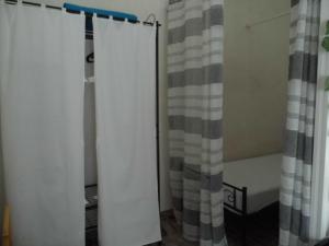 a room with two white curtains and a crib at Suite 7 &Home Restaurant in Paglieta +15 photos