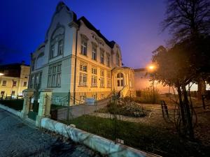 a large building is lit up at night at Apartmány ASTRA in Cheb