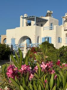 a house with flowers in front of it at Sea View Cycladic Home in Santa Maria