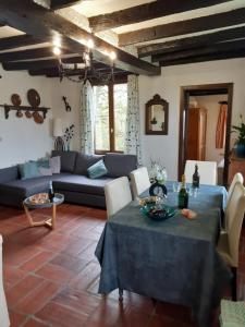 a living room with a blue couch and a table at La Bergerie in Froid-Chapelle