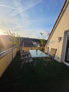 a patio with a table and chairs on a balcony at FeWO-Rafaelo 3 in Marsberg