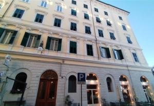 a white building with a parking sign in front of it at VelaMar in Trieste