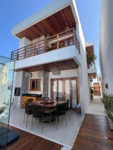 a house with a balcony with a table and chairs at Sunny Kite House Prea in Prea