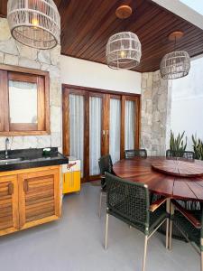 a dining room with a wooden table and chairs at Sunny Kite House Prea in Prea