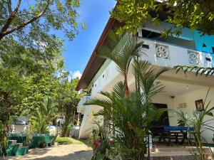 a house with palm trees in front of it at Nelum Vegan House in Bentota