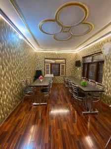 a room with tables and chairs and a large mirror at The sameer resort in Anantnāg