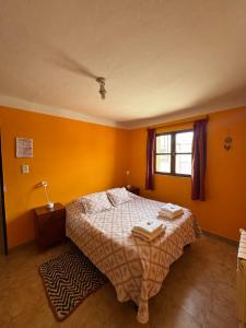 a bedroom with a bed with two towels on it at Sumaq Samay in San Antonio de los Cobres