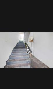 a stairway leading up to a white building at Hotel O Raas Near Peera garhi Metro Station in New Delhi