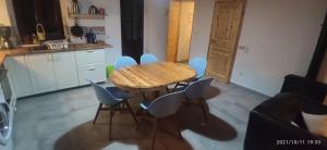 a kitchen with a wooden table and blue chairs at Villa Seaview in Oitylo
