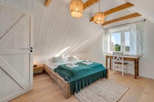 a bedroom with a bed and a desk and a window at U Pana Boga za piecem - domki w górach, Sauna, Beskidy, Koszarawa in Korbielów
