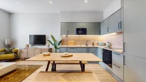 a kitchen with a wooden table in a room at The Sauchie in Glasgow