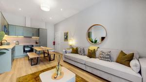 a living room and kitchen with a couch and a table at The Sauchie in Glasgow +35 photos
