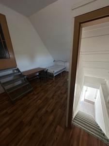 an attic room with a staircase and a bed at Monteurwohnung, 1 Zimmer Apartment in Bad Essen