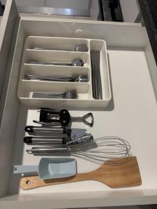 a drawer full of utensils in a refrigerator at Habitat Kappa Alexio in Gaborone