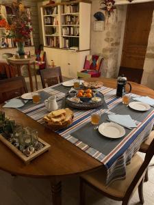 a wooden table with food on top of it at La Poitevinière in Sainte-Hermine