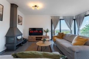 a living room with a couch and a fireplace at Piscina & BBQ | Cerca Costa Brava in Tordera