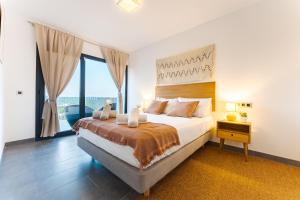 a bedroom with a large bed and a large window at Piscina & BBQ | Cerca Costa Brava in Tordera