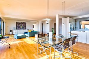 a dining room and living room with a glass table at Villa Bambou bei Cannes mit Blick auf Cap Antibes in Vallauris