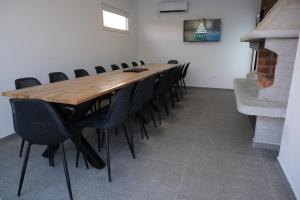 a conference room with a long wooden table and chairs at Luxury Villa JAKOV in Banja Luka +21 photos