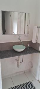 a bathroom counter with a sink and a mirror at Kasa Mare studios Maresias in São Sebastião +3 photos