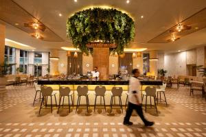 a man walks through the lobby of a restaurant at Riu Ventura - All Inclusive in Cancún